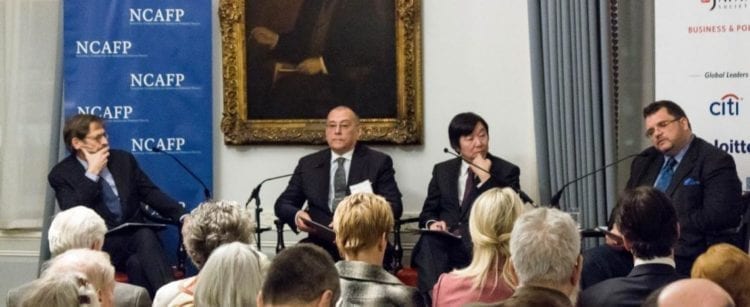 Participants in the U.S.-Russia-Japan Trilateral Conference address a public audience following the proceedings.